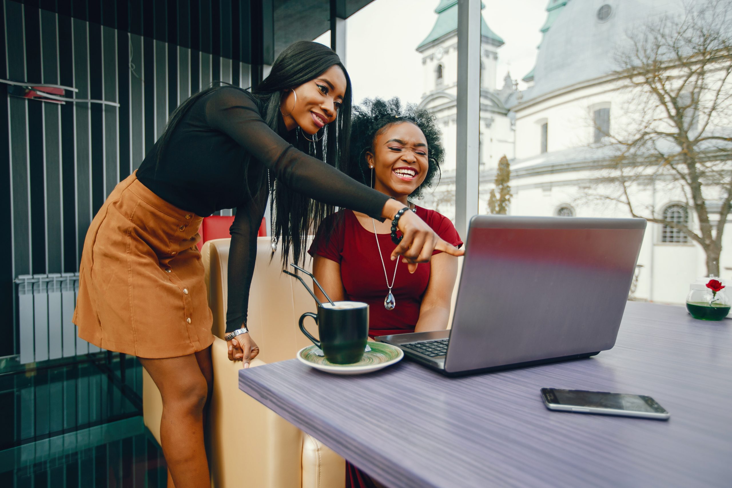 Team smiling at computer